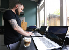 A man works in his kitchen while workers are forced to work from home and demand payback for extra home office costs during the coronavirus disease (COVID-19) outbreak in Sassenheim, Netherlands October 2, 2020. Picture taken October 2, 2020. 