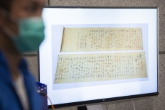 Police show a picture of a calligraphy scroll written by Mao Zedong worth about US$300 million, that had been recovered but found chopped in half following a robbery that included antique stamps and revolutionary items from mainland China worth an estimated US$645 million, at a press conference in Hong Kong on October 7, 2020.