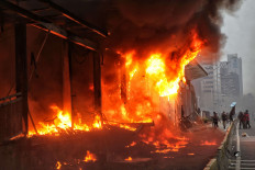 A Transjakarta bus station on Jl. MH Thamrin burns in Jakarta on Thursday during a protest against the Job Creation Law.