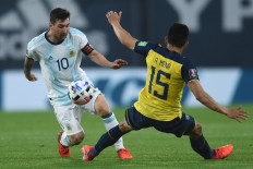 Argentina's Lionel Messi (left) eludes Ecuador's Angel Mena during its 2022 FIFA World Cup South American qualifier soccer match at La Bombonera stadium in Buenos Aires on Thursday, amid the COVID-19 pandemic. 


