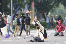 No violence: A protester holds up his arms while sitting in a road during a protest on Thursday, october 8. 2020 in Harmoni, Central Jakarta. The demonstration in the historic district descended into violence as a clash broke out between protesters and the police. JP/Wendra Ajistyatama 
