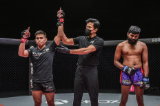 Indonesian wrestler Eko Roni Saputra (left) is declared the winner of his bout against Malaysian contender Murugan Silvarajoo in the first round of ONE: REIGN OF DYNASTIES on Friday