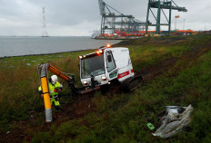 A worker at Port of Antwerp uses a 'vacuum cleaner' to remove plastic trash from the Galgeschoor nature reserve in Antwerp, Belgium, on October 7, 2020. 