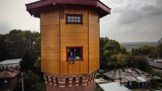 Russian businessman Alexander Lunev sits on the window of a former water tower, which he bought and turned into his apartment, in the Siberian city of Tomsk on September 7, 2020. 