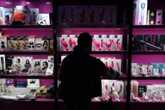 This photo taken on October 14, 2020 shows manager Li Hong in front of a display of sex toys at her sex store in Beijing. 