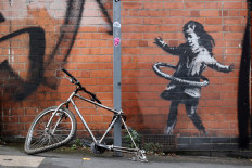 British artist Banksy claims hula-hooping girl street art