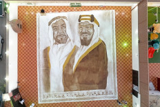 A handout picture released by the Guinness World Records on October 18, 2020 shows the world's largest coffee painting by Saudi artist Ohud Abdullah Almalki depicting founding fathers of Saudi Arabia and the UAE, the late King Abdulaziz bin Abdul Rahman (right) and the late Sheikh Zayed bin Sultan Al Nahyan, in Jeddah. 