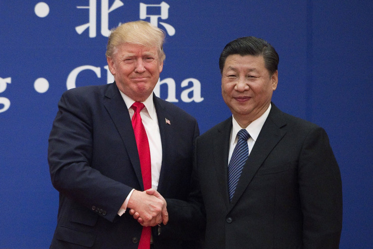 In this file photo taken on Nov.8, 2017 US President Donald Trump (left) and China's President Xi Jinping shake hands during a business leaders event at the Great Hall of the People in Beijing. US President Donald Trump, who is seeking reelection on Nov 3, has regularly jolted the world with statements about other leaders that sharply deviate .from long-held diplomatic protocol.
