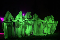 Actresses perform in the La Llorona folk play, at the Cuemanco pier in the 'chinampas' of Lake Xochimilco, small artificial islands and causeways created by the Aztecs in wetlands, in southern Mexico City, on October 18, 2020, amid the COVID-19 novel coronavirus pandemic. 