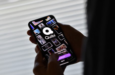 This illustration photo shows a person about to use the Quibi app on a smart phone in Los Angeles, October 21, 2020. 