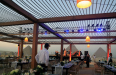 Egyptian waiters and employees take their positions during the opening of a new restaurant called '9 Pyramids Lounge' by Orascom Pyramids Entertainment (OPE), amid the coronavirus disease (COVID-19) outbreak, at the Great Pyramids in Giza, Egypt, on October 20, 2020. 
