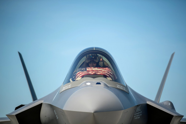 An F-35 pilot prepares for take off from the Vermont Air National Guard Base with the flag of the United States, before a flyover in South Burlington, Vermont, U.S. May 22. 