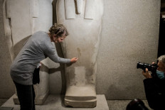 Friederike Seyfried, director of the Egyptian Museum Berlin points to the damage caused by an 'oily liquid' leaving visible stains on exhibits in the Egyptian part of the Neues Museum on October 21, 2020 in Berlin. 