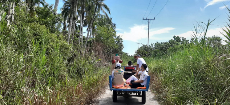 Doctor Laili Candrawati's team rides on a motorized tricycle to distribute COVID-19 information to villagers in the Hibala subdistrict of South Nias regency in North Sumatra. Medical workers in the region provided COVID-19 information otherwise unavailable due to a lack of access to electricity, television and the internet.
