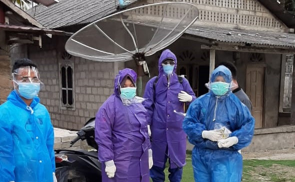 Doctor Laili Candrawati (right) and her team are wrapped up in self-made personal protective equipment in the early months of the COVID-19 epidemic as hazmat suits, face shields and boots had yet to reach the remote area of Hibala subdistrict, South Nias regency, North Sumatra.