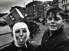 A handout picture taken by Dutch photographer Ed Van Der Elsken and released by the Rijksmuseum shows youth, one sticking out his tongue as they pose in a street, a picture of the unpublished book 'Feest', which means 'to party' in Dutch, compiling photographs which captured 'life in his own raw style' and an era from the 1950s to the early 60s. 
