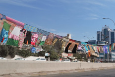 An artwork by Iraqi visual artist Tara Abdallah hangs above a highway in the city of Sulaimaniyah in Iraq's autonomous northern Kurdish region, on October 26, 2020. 