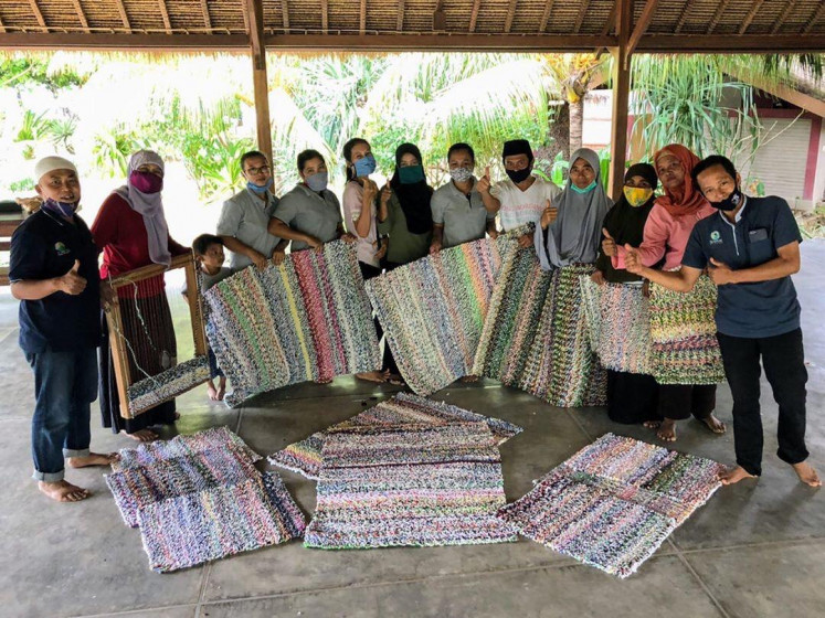 Plastic fantastic: Craftspeople who work for the Plastik Kembali initiative at Selong Belanak Beach in
Lombok, West Nusa Tenggara, pose together for a photograph with the rugs they have woven using recycled plastic. The Plastik Kembali initiative resumed its production activities in August. It aims to support local craftspeople as their income has decreased as a result of the pandemic, while tackling the local plastic waste problem at the same time.