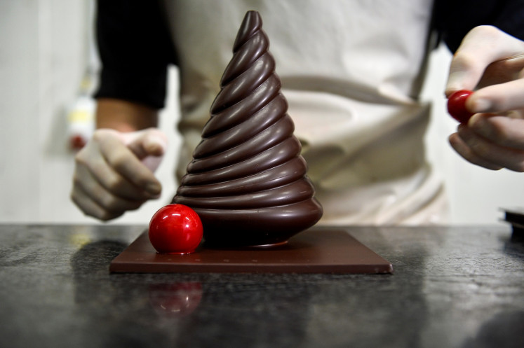 A worker prepares a pastry at the workshop of Belgian chocolate maker Marcolini, a day after the company's founder Pierre Marcolini was awarded the title of best pastry chef in the world, in Brussels, Belgium, on October 27, 2020. 