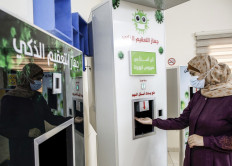 Palestinian entrepreneur Heba al-Hindi demonstrates a locally-designed and manufactured smart sterilization device in Gaza City on October 8, 2020, as the machine is to be to be deployed across various facilities in the Gaza Strip as part of efforts to curb the spread of COVID-19 coronavirus disease. 