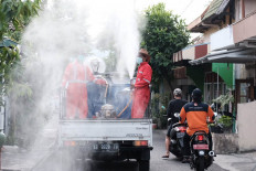 Sanitation workers spray disinfectant on the streets of Wijilan Kidul, Yogyakarta. 