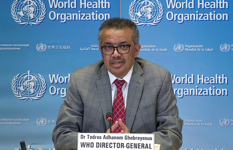 In this file photo taken on March 30, a TV grab taken from the World Health Organization website shows WHO Chief Tedros Adhanom Ghebreyesus via video link as he delivers a news briefing on COVID-19  from the WHO headquarters in Geneva. 