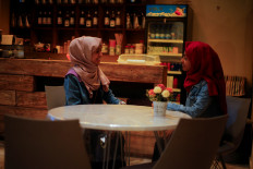 Women talk as they sit in the only all-female internet cafe in Marib, Yemen, on October 13, 2020. 