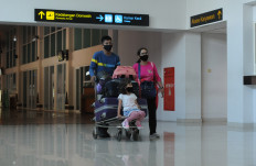 Travelers walk through the departure terminal at Adi Soemarmo Airport in Boyolali, Central Java, on Oct. 1. Statistics Indonesia data show that the number of domestic air passengers between January and August fell 56.99 percent year-on-year (yoy) to 21.6 million people.
