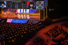 China's Suning team (right) and South Korea's Damwon team compete in the League of Legends World Video Game Championships final at SAIC Pudong Football Stadium in Shanghai on October 31, 2020.