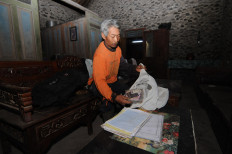 A resident living near Mount Merapi in Selo, Boyolali, Central Java, packs his belongings before going to a shelter in preparation for the forecast eruption on Nov. 6.