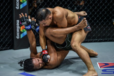Indonesian fighter Eko Roni Saputra (right) manages to corner his opponent, Ramon Gonzales of the Philippines, at Friday's ONE:INSIDE THE MATRIX II, which was aired from Singapore. Eko won the fight in less than five minutes.