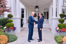 Then-US Vice President Joe Biden (left) greets Indonesian President Joko 'Jokowi' Widodo at the official vice presidential residence during the latter's visit to the US on Oct. 15, 2015.