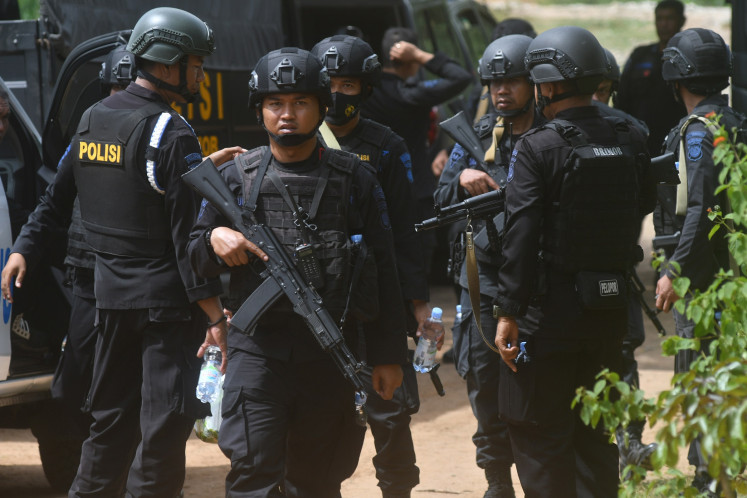Members of The National Police's Mobile Brigade sweep the location suspected to be the hiding place of alleged terrorists in the hilly areas of Mamboro district, North Palu, Central Sulawesi on Sunday, Nov. 8, 2020.  The joint team of Densus 88 anti-terrorism squad, Brimob and Indonesian Military (TNI) hunt for a wanted terrorist suspect in hideout.