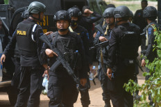 Members of The National Police's Mobile Brigade sweep the location suspected to be the hiding place of alleged terrorists in the hilly areas of Mamboro district, North Palu, Central Sulawesi on Sunday, Nov. 8, 2020.  The joint team of Densus 88 anti-terrorism squad, Brimob and Indonesian Military (TNI) hunt for a wanted terrorist suspect in hideout.