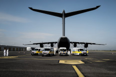 A French army Airbus A400 M waits as members of the medical staff prepare to transfer Covid-19 patients from Lyon-Bron aerodrome to the French capital Paris on November 10, 2020, amid a surge in COVID-19 cases in France. 