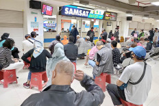 Better late than never: Vehicle owners wait for their turn to pay vehicle tax at ITC Depok in Depok, West Java, on Nov. 10, 2020. The West Java provincial administration is waiving penalties for late vehicle tax payments and other vehicle-related fees to reduce the burden on vehicle owners amid the COVID-19 pandemic as well as to woo owners to pay their vehicle taxes.