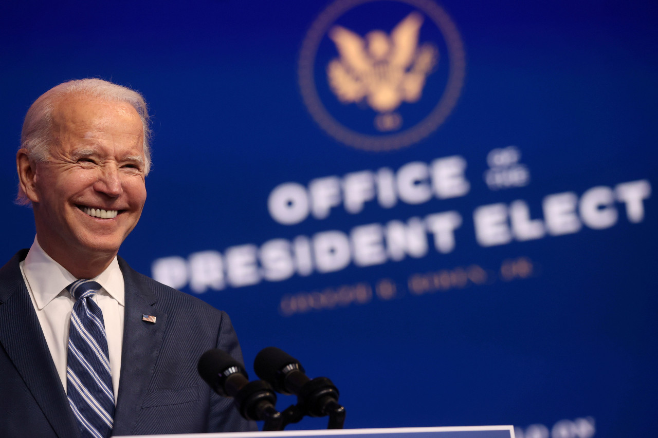 US President-elect Joe Biden smiles as he speaks about health care and the Affordable Care Act (Obamacare) at the theater serving as his transition headquarters in Wilmington, Delaware, US on Tuesday