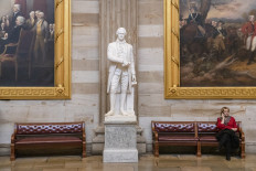  A woman sits next to a state of Alexander Hamilton in the Capitol Rotunda on February 5, 2020 in Washington, DC. 