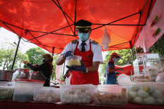 Malaysian former pilot Azrin Mohamad Zawawi prepares food at his food stall in Subang Jaya, Malaysia, on November 7, 2020. 