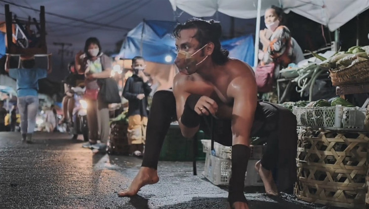 Among us: Balinese dancer I Putu Bagus Bang Sada Graha Saputra performs 'Buron Peken' (Market Animal), mimicking a dog in a wet market and interacting with onlookers.