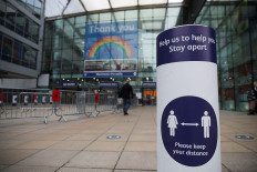 A social distancing sign is seen at the entrance to Manchester Piccadilly station is seen amid the coronavirus disease (COVID-19) pandemic in Manchester, Britain, November 11, 2020. 