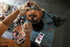 Brazil artist paints masks for those who want to show their face