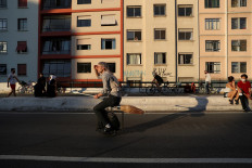 Alessandro Russo rides an electric monowheel called 'nuvem' (cloud), which he invented with his friend Vinicius Sanctus and is inspired by the magic flying brooms of the Harry Potter series, at Minhocao bridge in Sao Paulo, Brazil, on November 7, 2020. 