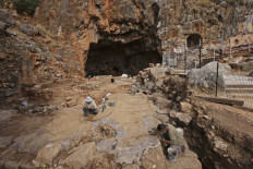 Employees with Israel Nature and Parks Authority are pictured during preservation work of a Hellenistic, Roman and the Byzantine periods site, at the Banias Nature Reserve in the Israeli-annexed Golan Heights on November 11, 2020. 