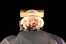 Thai pro-democracy protesters scale Bangkok monument and rappers take aim at monarchy 