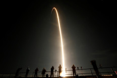 People watch as a SpaceX Falcon 9 rocket, topped with the Crew Dragon capsule, is launched carrying four astronauts on the first operational NASA commercial crew mission at Kennedy Space Center in Cape Canaveral, Florida, United States, on November 15, 2020. 
