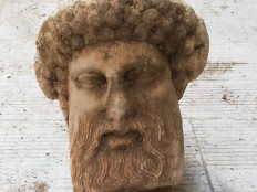 This handout picture released by the Greek Culture Ministry on November 15, 2020, shows the head of an ancient statue of the Greek god Hermes which has been unearthed during excavations for sewage system improvements in central Athens.