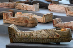 A picture shows wooden sarcophagi on display during the unveiling of an ancient treasure trove of more than a 100 intact sarcophagi, at the Saqqara necropolis 30 kilometers south of the Egyptian capital Cairo, on November 14, 2020. 