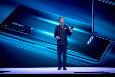 This file photo taken on May 21, 2019 shows George Zhao, the president of Honor, a sub-brand of Chinese telecommunications company Huawei, speaking during a keynote speech at an event to launch the Honor 20 Series smartphones at Battersea Evolution in London. 