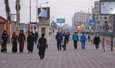 Palestinians walk on the Mediterranean beachfront promenade at dawn amid the COVID-19 pandemic, in Gaza City, on November 11, 2020. 